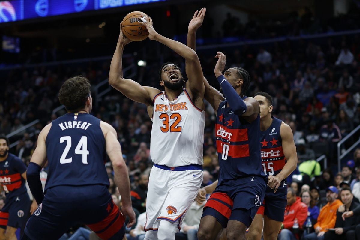 Dec 28, 2024; Washington, District of Columbia, USA; New York Knicks center Karl-Anthony Towns (32) shoots the ball as Washington Wizards forward Alexandre Sarr (20) defends in the first quarter at Capital One Arena. Mandatory Credit: Geoff Burke-Imagn Images