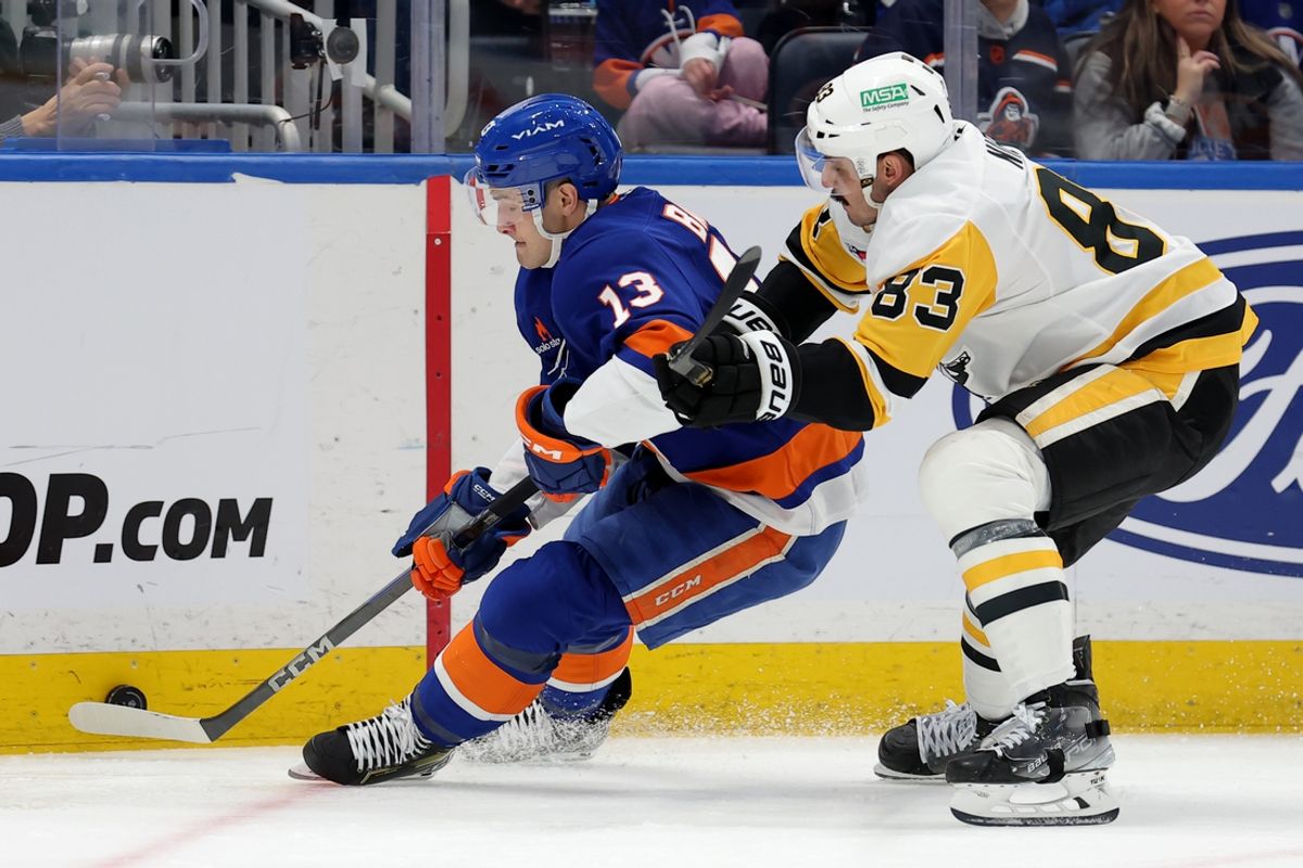 Dec 28, 2024; Elmont, New York, USA; New York Islanders center Mathew Barzal (13) fights for the puck against Pittsburgh Penguins left wing Matt Nieto (83) during the first period at UBS Arena. Mandatory Credit: Brad Penner-Imagn Images