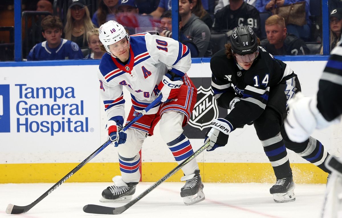 Dec 28, 2024; Tampa, Florida, USA; Tampa Bay Lightning center Conor Geekie (14) defends New York Rangers left wing Artemi Panarin (10) during the second period at Amalie Arena. Mandatory Credit: Kim Klement Neitzel-Imagn Images