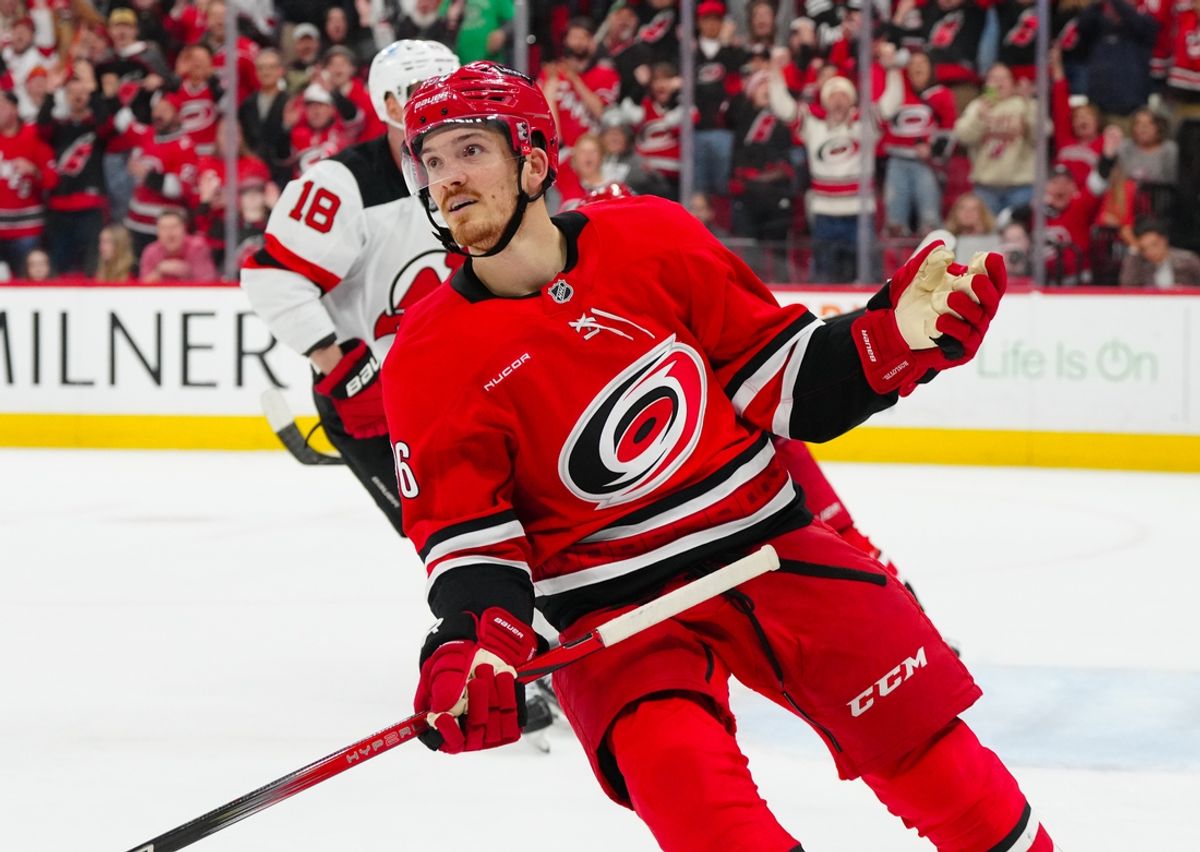 Dec 28, 2024; Raleigh, North Carolina, USA;  Carolina Hurricanes center Jack Roslovic (96) celebrates his empty net goal against the New Jersey Devils during the third period at Lenovo Center. Mandatory Credit: James Guillory-Imagn Images