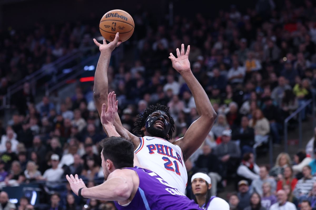 Dec 28, 2024; Salt Lake City, Utah, USA; Philadelphia 76ers center Joel Embiid (21) is fouled by Utah Jazz forward Drew Eubanks (15) during the second quarter at Delta Center. Mandatory Credit: Rob Gray-Imagn Images