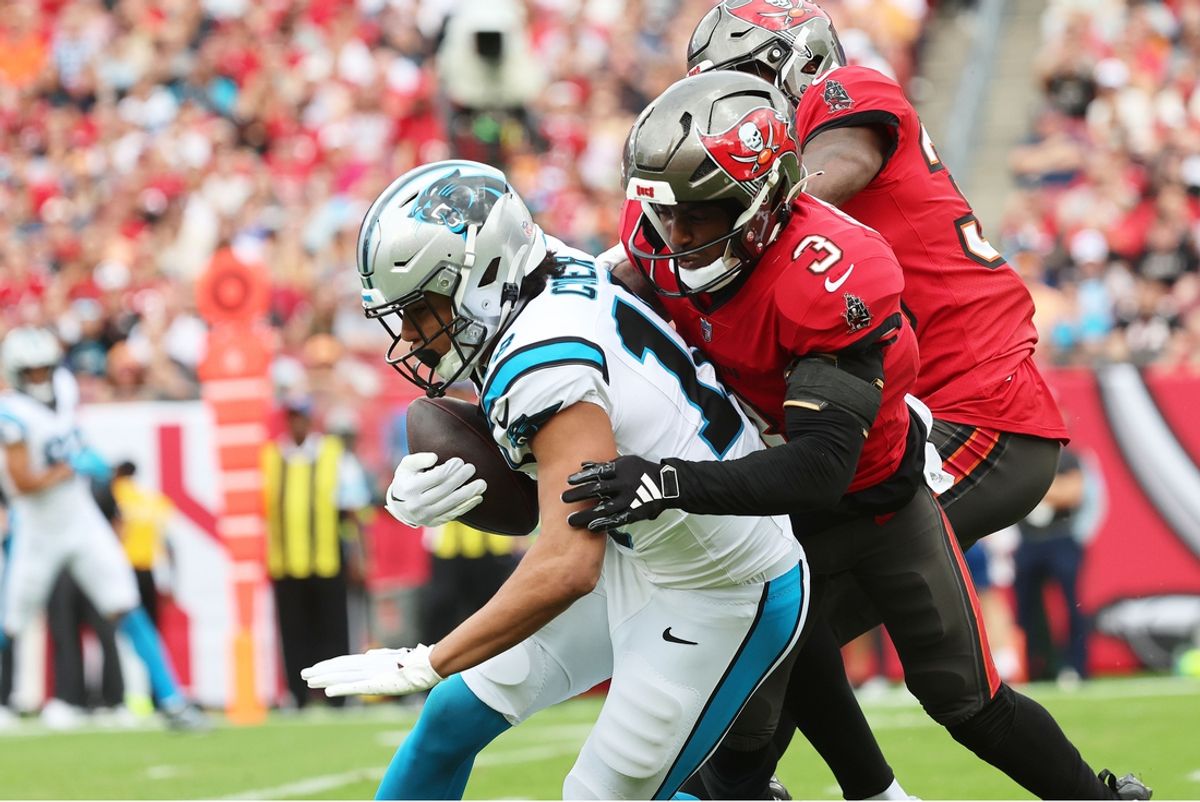 Dec 29, 2024; Tampa, Florida, USA; Carolina Panthers wide receiver Jalen Coker (18) runs with the ball as Tampa Bay Buccaneers safety Jordan Whitehead (3) defends during the first quarter at Raymond James Stadium. Mandatory Credit: Kim Klement Neitzel-Imagn Images