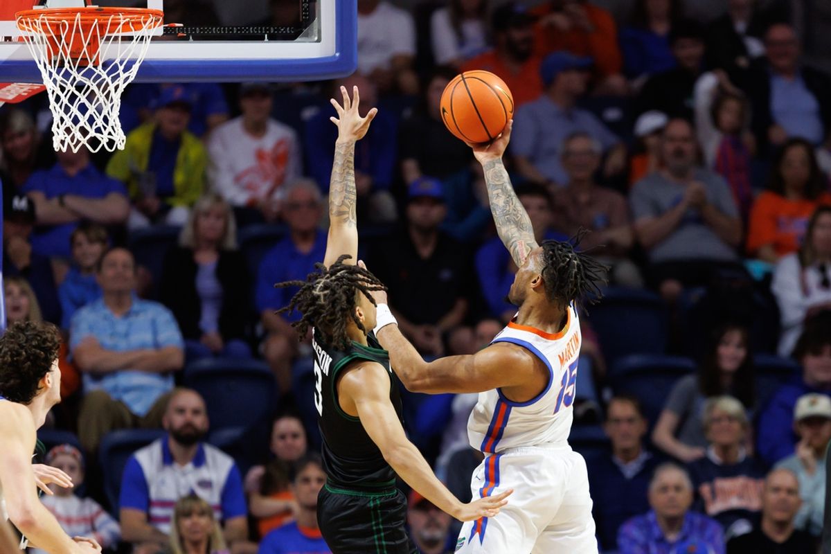 Dec 29, 2024; Gainesville, Florida, USA; Florida Gators guard Alijah Martin (15) shoots over Stetson Hatters guard Mehki Ellison (3) during the first half at Exactech Arena at the Stephen C. O'Connell Center. Mandatory Credit: Matt Pendleton-Imagn Images