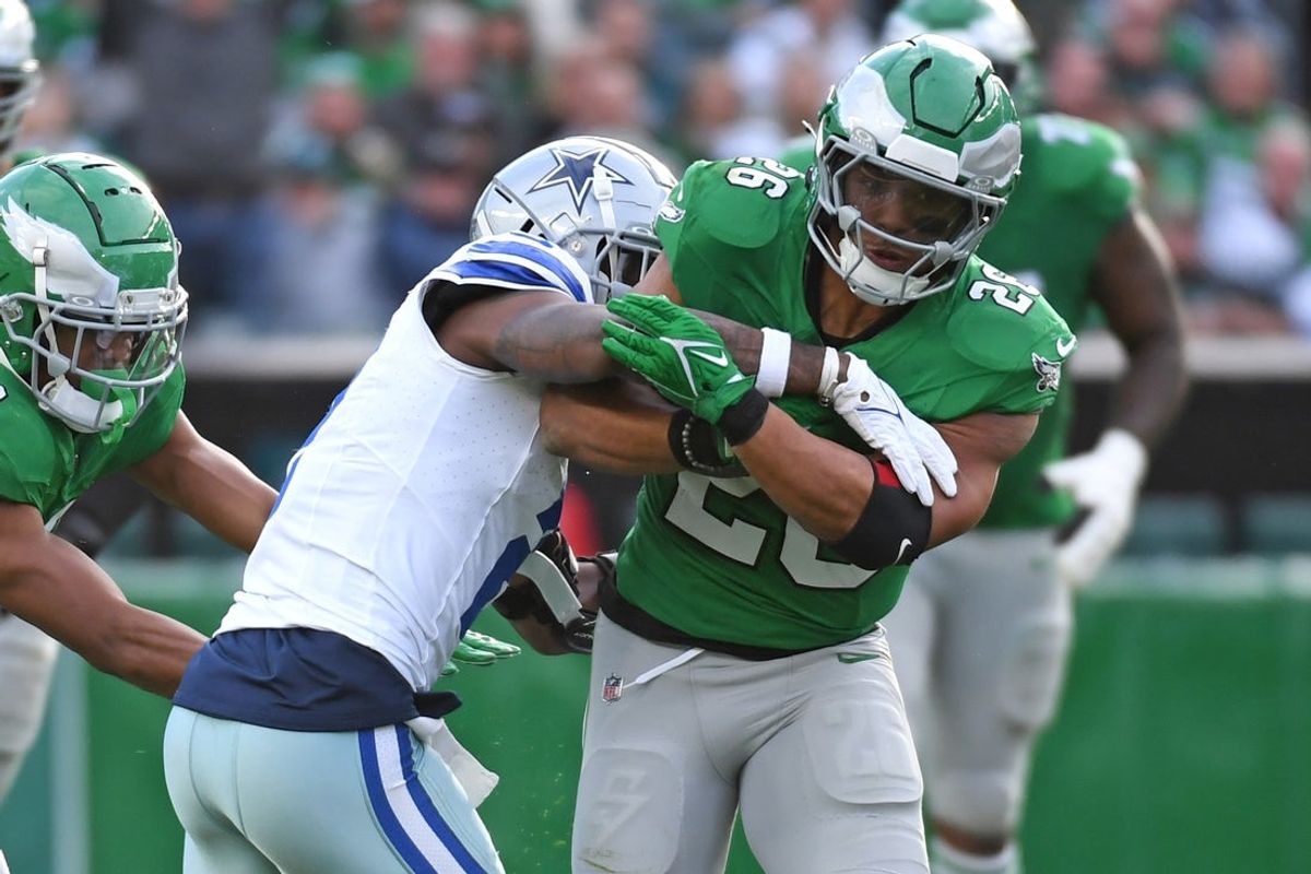 Dec 29, 2024; Philadelphia, Pennsylvania, USA; Philadelphia Eagles running back Saquon Barkley (26) is tackled by Dallas Cowboys cornerback Jourdan Lewis (2)  during the second quarter at Lincoln Financial Field. Mandatory Credit: Eric Hartline-Imagn Images