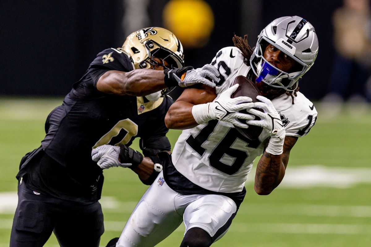 Dec 29, 2024; New Orleans, Louisiana, USA;  Las Vegas Raiders wide receiver Jakobi Meyers (16) catches a pass against New Orleans Saints safety Ugo Amadi (0) during the first half at Caesars Superdome. Mandatory Credit: Stephen Lew-Imagn Images