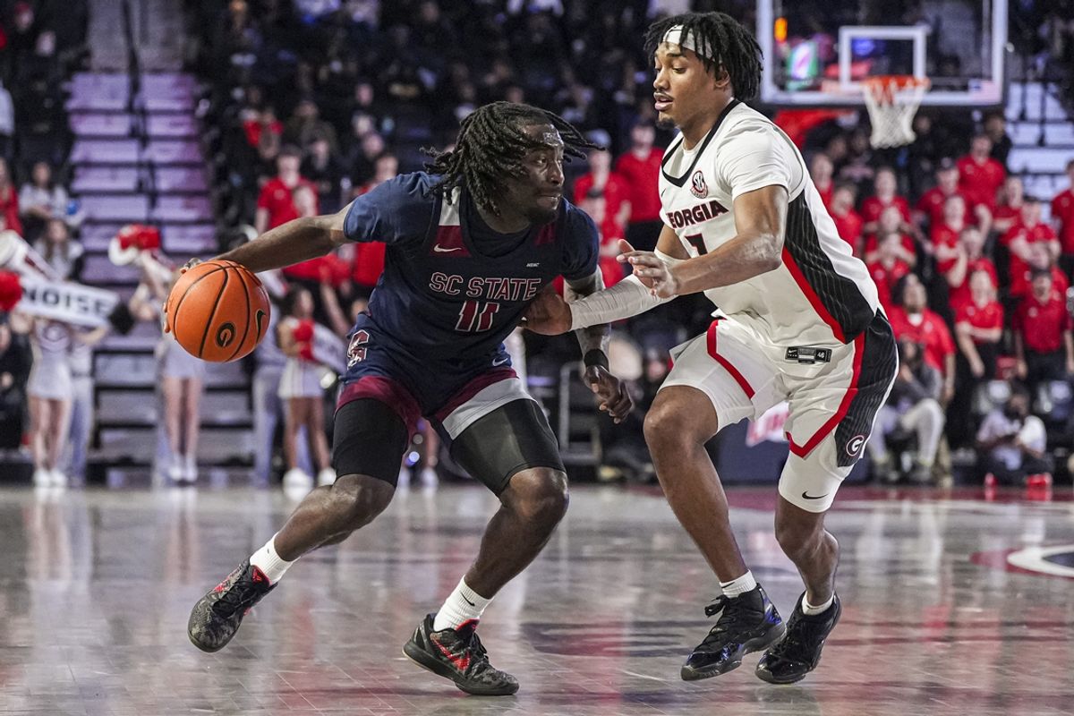 Dec 29, 2024; Athens, Georgia, USA; South Carolina State Bulldogs guard Wilson Dubinsky (11) dribbles against Georgia Bulldogs guard Tyrin Lawrence (7) during the first half at Stegeman Coliseum. Mandatory Credit: Dale Zanine-Imagn Images