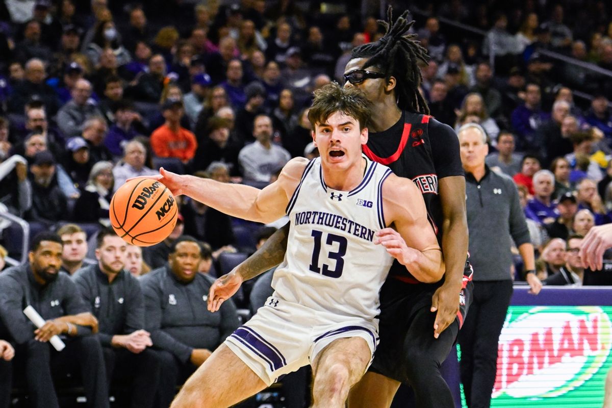 Dec 29, 2024; Evanston, Illinois, USA; Northwestern Wildcats guard Brooks Barnhizer (13) moves the ball against Northeastern Huskies guard Harold Woods (10)  during the second half at Welsh-Ryan Arena. Mandatory Credit: Matt Marton-Imagn Images