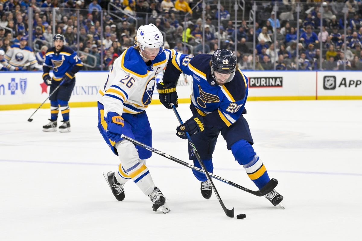 Dec 29, 2024; St. Louis, Missouri, USA;  St. Louis Blues left wing Brandon Saad (20) controls the puck as Buffalo Sabres defenseman Rasmus Dahlin (26) defends during the second period at Enterprise Center. Mandatory Credit: Jeff Curry-Imagn Images