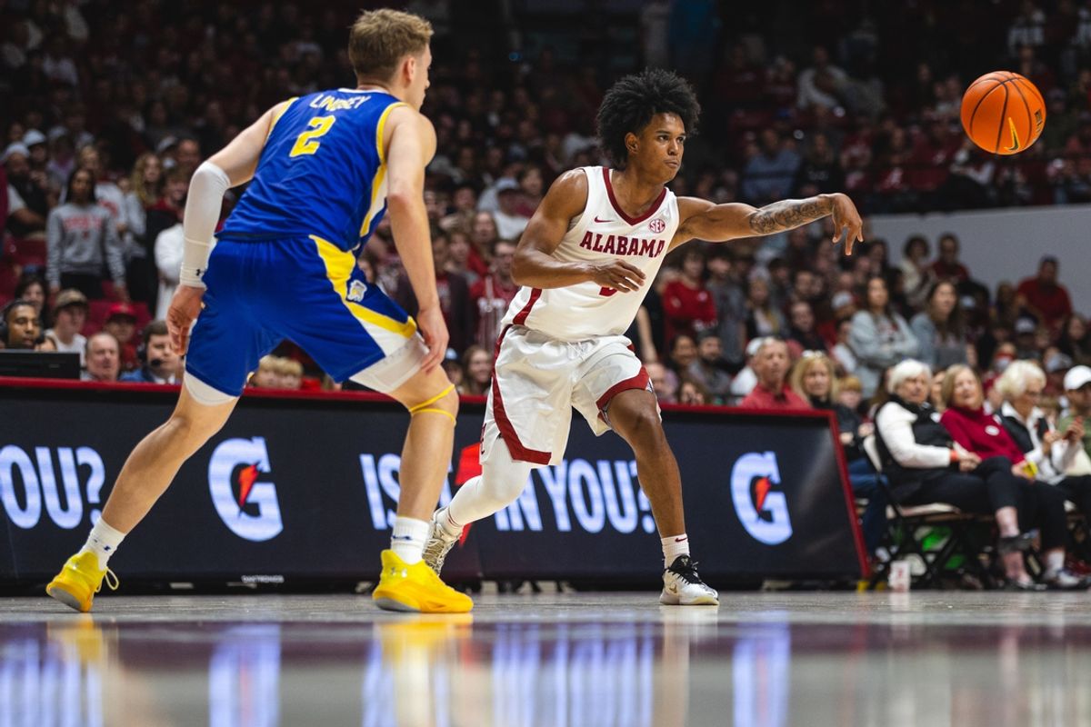 Dec 29, 2024; Tuscaloosa, Alabama, USA; Alabama Crimson Tide guard Aden Holloway (2) passes the ball against South Dakota State Jackrabbits guard Isaac Lindsey (2) during the second half at Coleman Coliseum. Mandatory Credit: Will McLelland-Imagn Images