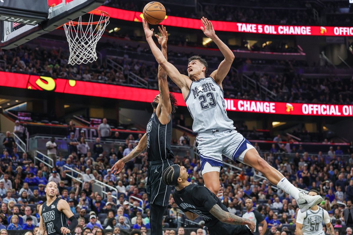 Dec 29, 2024; Orlando, Florida, USA; Orlando Magic forward Tristan da Silva (23) goes to the basket against Brooklyn Nets center Nic Claxton (33) during the second half at Kia Center. Mandatory Credit: Mike Watters-Imagn Images