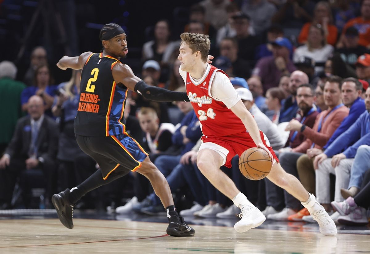 Dec 29, 2024; Oklahoma City, Oklahoma, USA; Memphis Grizzlies guard Cam Spencer (24) drives to the basket around Oklahoma City Thunder guard Shai Gilgeous-Alexander (2) during the second quarter at Paycom Center. Mandatory Credit: Alonzo Adams-Imagn Images