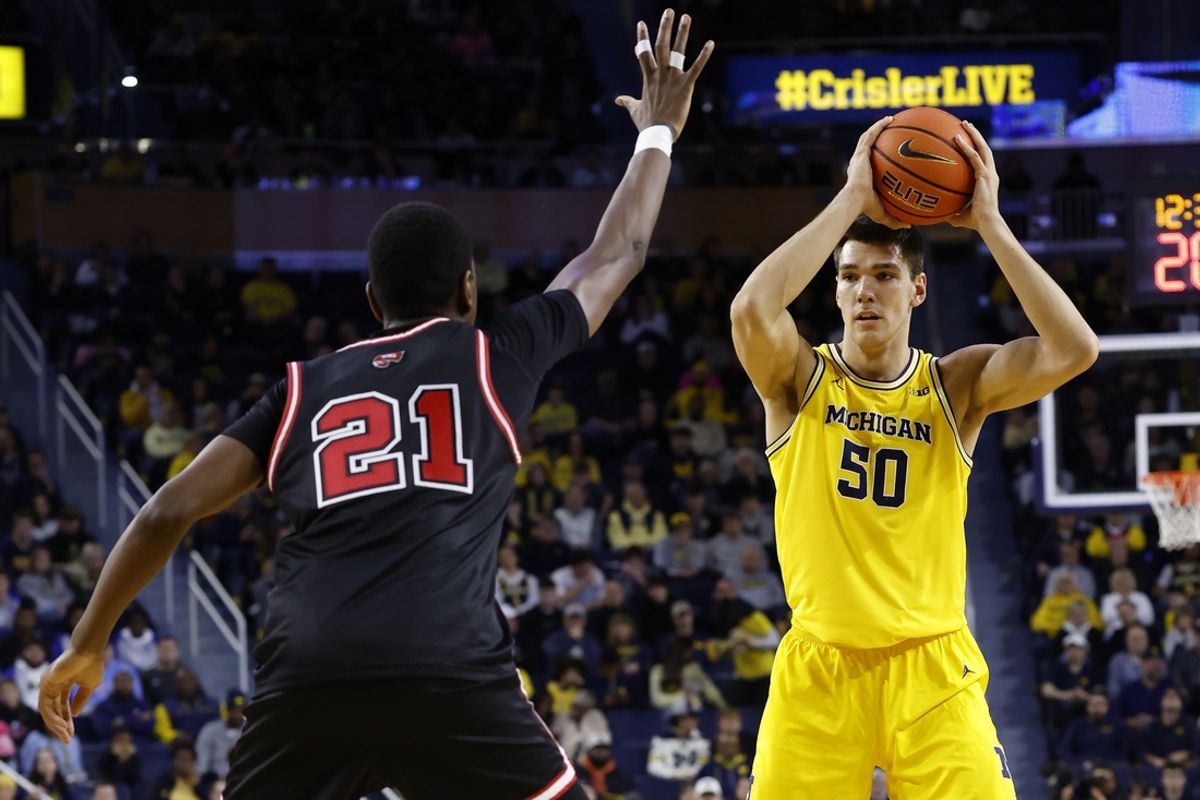 Dec 29, 2024; Ann Arbor, Michigan, USA;  Michigan Wolverines center Vladislav Goldin (50) with the ball against Western Kentucky Hilltoppers forward Leeroy Odiahi (21) in the first half at Crisler Center. Mandatory Credit: Rick Osentoski-Imagn Images