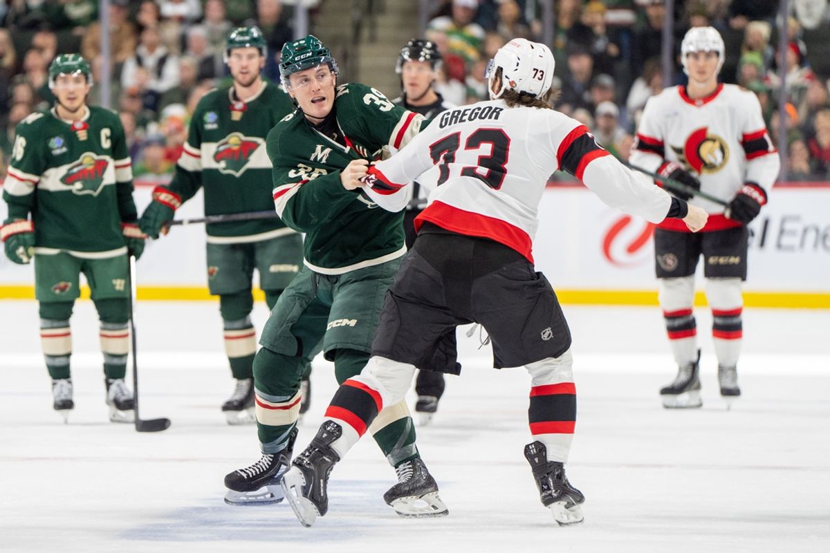 Dec 29, 2024; Saint Paul, Minnesota, USA; Minnesota Wild center Ben Jones (39) and Ottawa Senators left wing Noah Gregor (73) fight in the second period at Xcel Energy Center. Mandatory Credit: Matt Blewett-Imagn Images