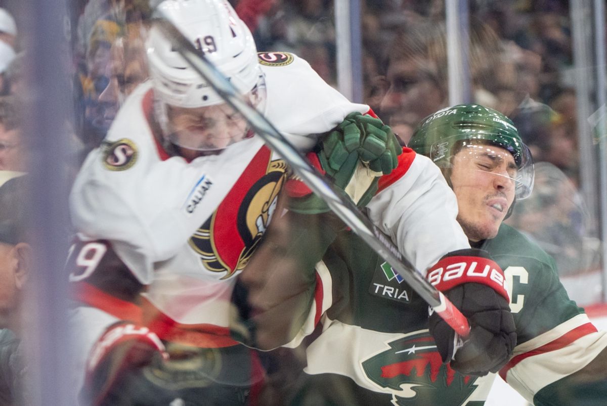 Dec 29, 2024; Saint Paul, Minnesota, USA; Ottawa Senators right wing Drake Batherson (19) checks Minnesota Wild defenseman Jared Spurgeon (46) in the third period at Xcel Energy Center. Mandatory Credit: Matt Blewett-Imagn Images