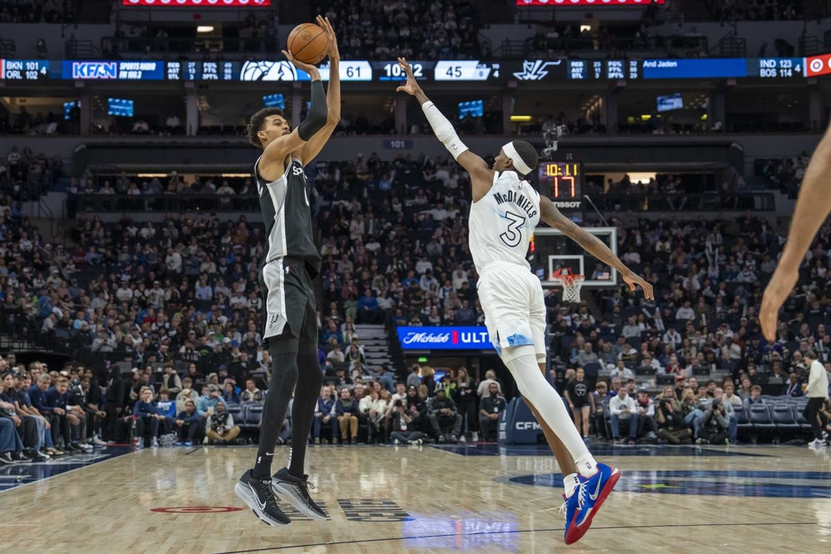 Dec 29, 2024; Minneapolis, Minnesota, USA; San Antonio Spurs center Victor Wembanyama (1) shoots the ball over Minnesota Timberwolves forward Jaden McDaniels (3) in the second half at Target Center. Mandatory Credit: Jesse Johnson-Imagn Images