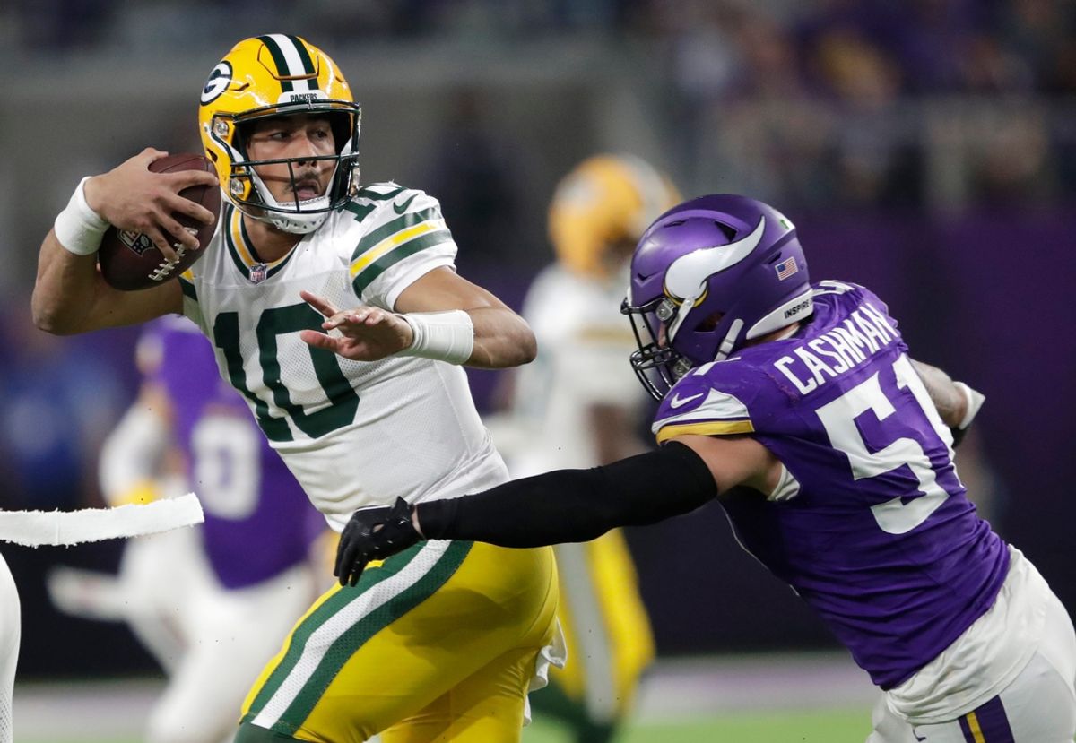 Green Bay Packers quarterback Jordan Love (10) is tackled by Minnesota Vikings linebacker Blake Cashman (51) in the fourth quarter during their football game Sunday, December 29, 2024, at U.S. Bank Stadium in Minneapolis, Minnesota.