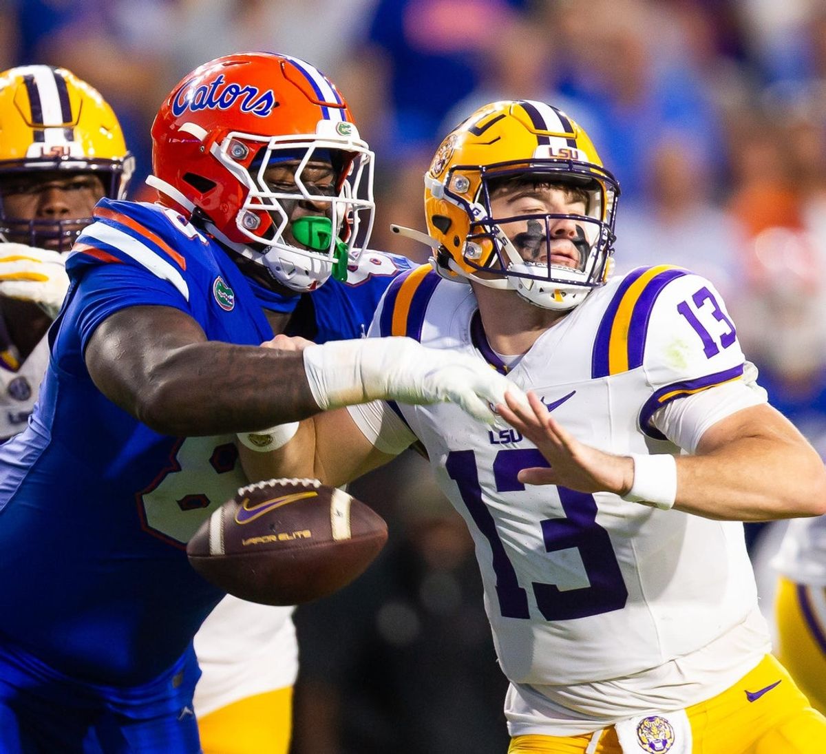 Florida Gators defensive lineman Caleb Banks (88) causes a fumble as he strips the ball from LSU Tigers quarterback Garrett Nussmeier (13) during the second half at Ben Hill Griffin Stadium in Gainesville, FL on Saturday, November 16, 2024. The Gators defeated the Tigers 27-16. [Doug Engle/Gainesville Sun]