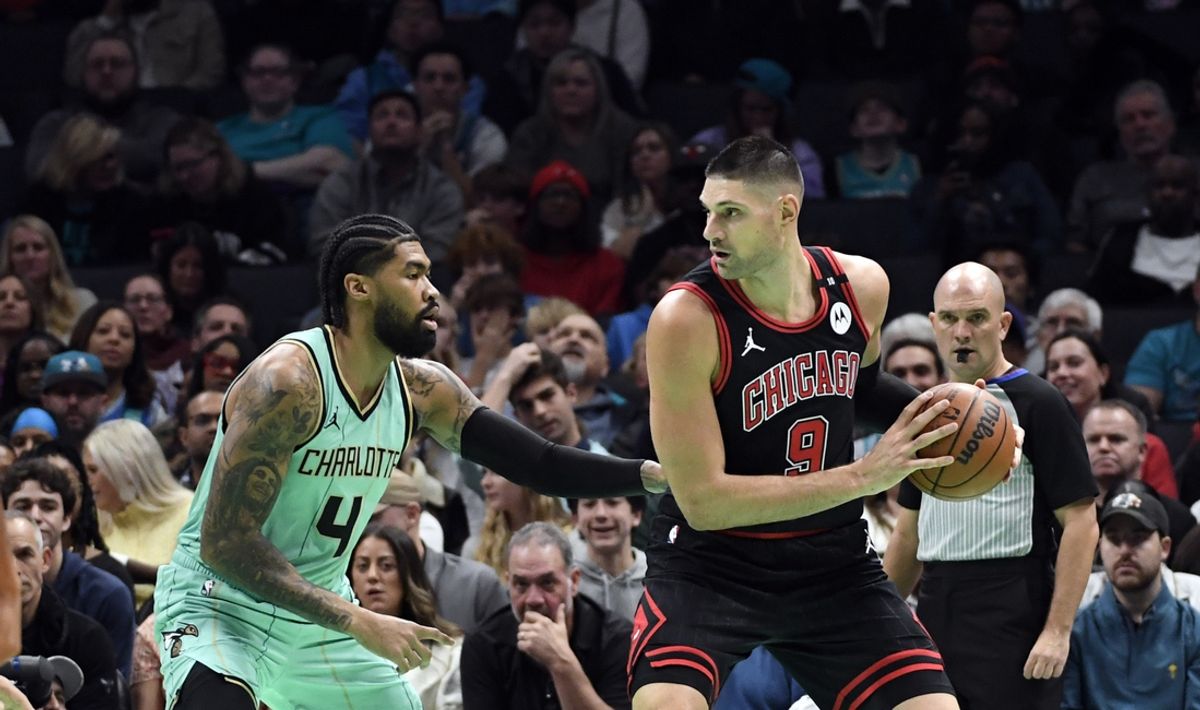 Dec 30, 2024; Charlotte, North Carolina, USA;  Chicago Bulls center Nikola Vucevic (9) looks to shoot as he is defended by Charlotte Hornets center Nick Richards (4) during the first half at the Spectrum Center. Mandatory Credit: Sam Sharpe-Imagn Images