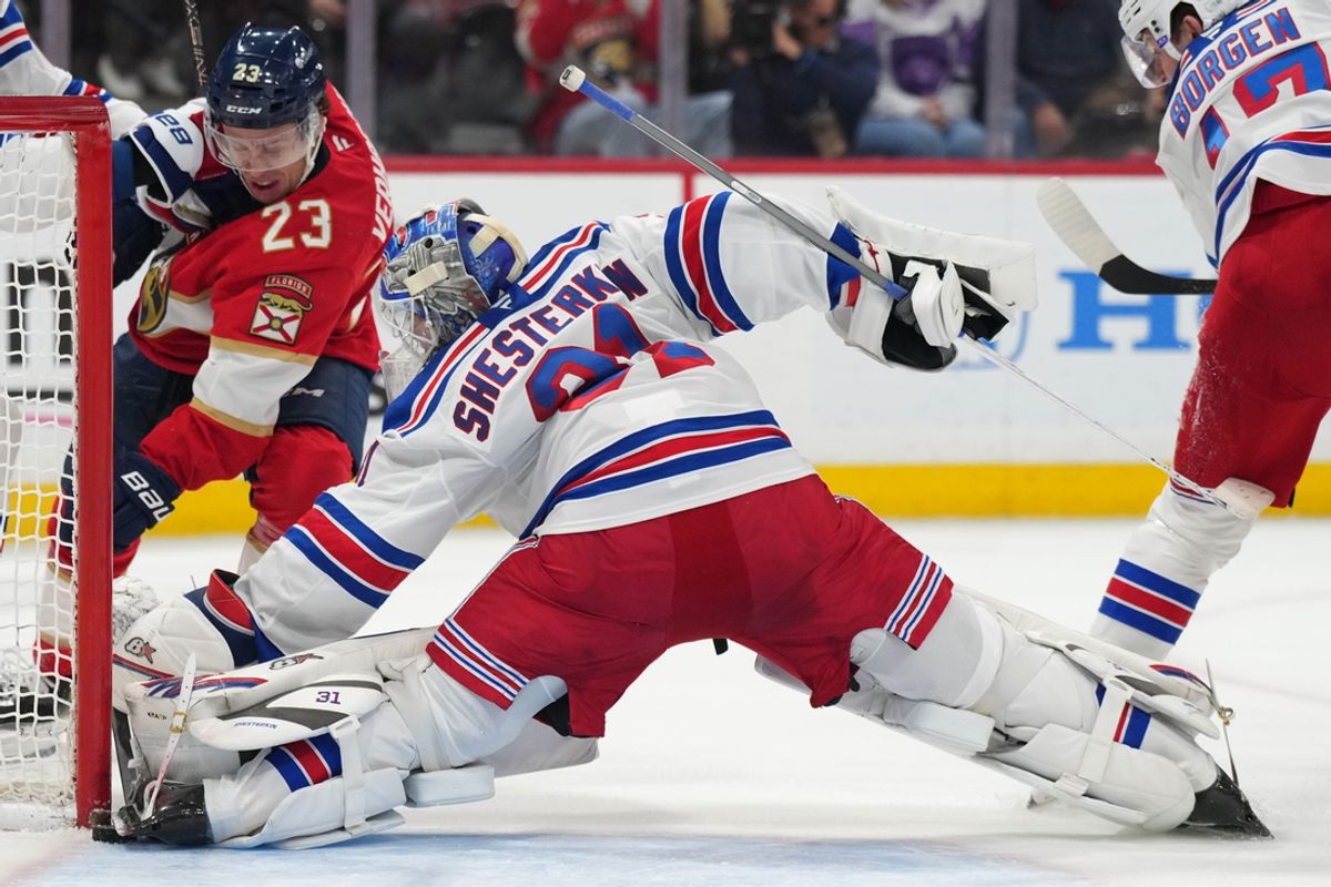 Dec 30, 2024; Sunrise, Florida, USA;  New York Rangers goaltender Igor Shesterkin (31) pins the puck against the post as Florida Panthers center Carter Verhaeghe (23) closes in during the second period at Amerant Bank Arena. Mandatory Credit: Jim Rassol-Imagn Images