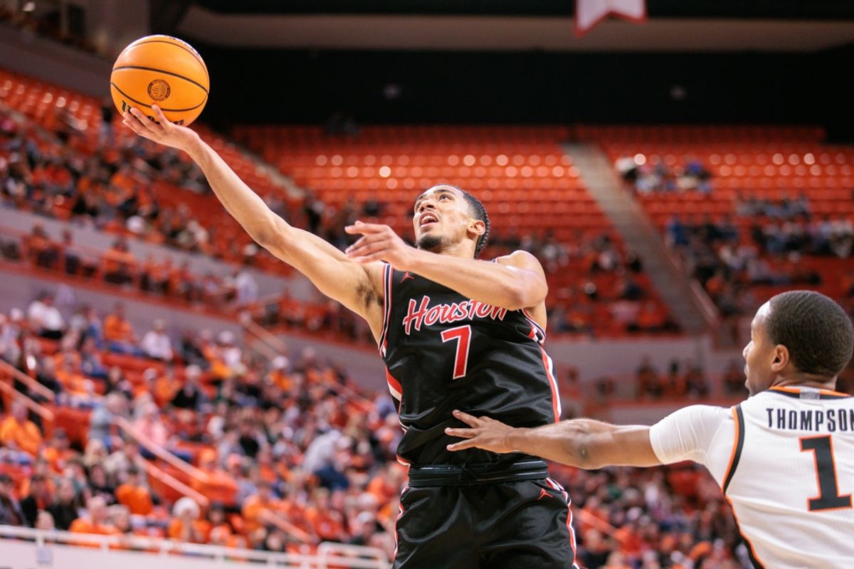 Dec 30, 2024; Stillwater, Oklahoma, USA; Houston Cougars guard Milos Uzan (7) shoots the ball during the second half against the Oklahoma State Cowboys at Gallagher-Iba Arena. Mandatory Credit: William Purnell-Imagn Images