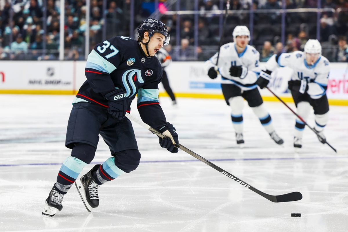 Dec 30, 2024; Seattle, Washington, USA; Seattle Kraken center Yanni Gourde (37) lines up a shot attempt against the Utah Hockey Club during the third period at Climate Pledge Arena. Mandatory Credit: Joe Nicholson-Imagn Images