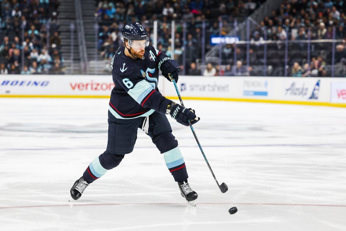 Dec 30, 2024; Seattle, Washington, USA; Seattle Kraken defenseman Adam Larsson (6) shoots the puck against the Utah Hockey Club during the third period at Climate Pledge Arena. Mandatory Credit: Joe Nicholson-Imagn Images