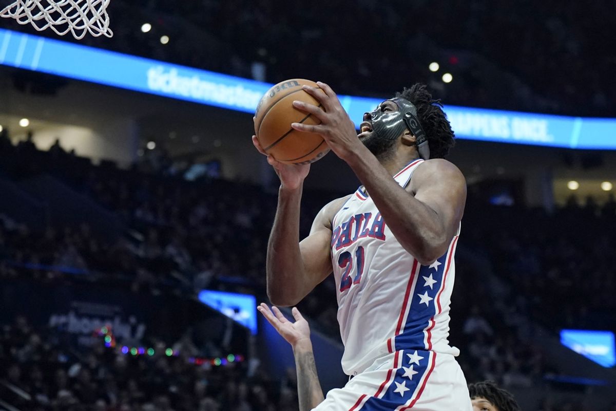 Dec 30, 2024; Portland, Oregon, USA; Philadelphia 76ers center Joel Embiid (21) drives to the basket past Portland Trail Blazers shooting guard Anfernee Simons (1, not pictured) during the first half at Moda Center. Mandatory Credit: Soobum Im-Imagn Images