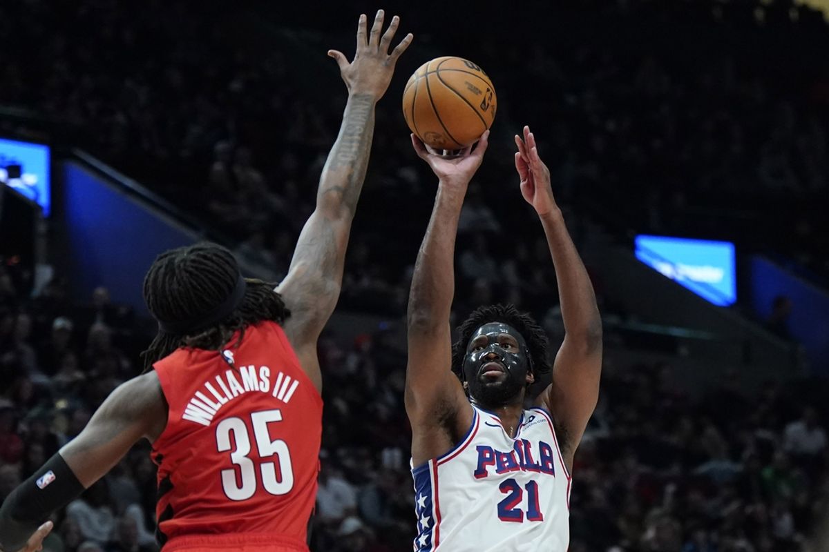 Dec 30, 2024; Portland, Oregon, USA; Philadelphia 76ers center Joel Embiid (21) shoots the ball over Portland Trail Blazers center Robert Williams III (35) during the first half at Moda Center. Mandatory Credit: Soobum Im-Imagn Images