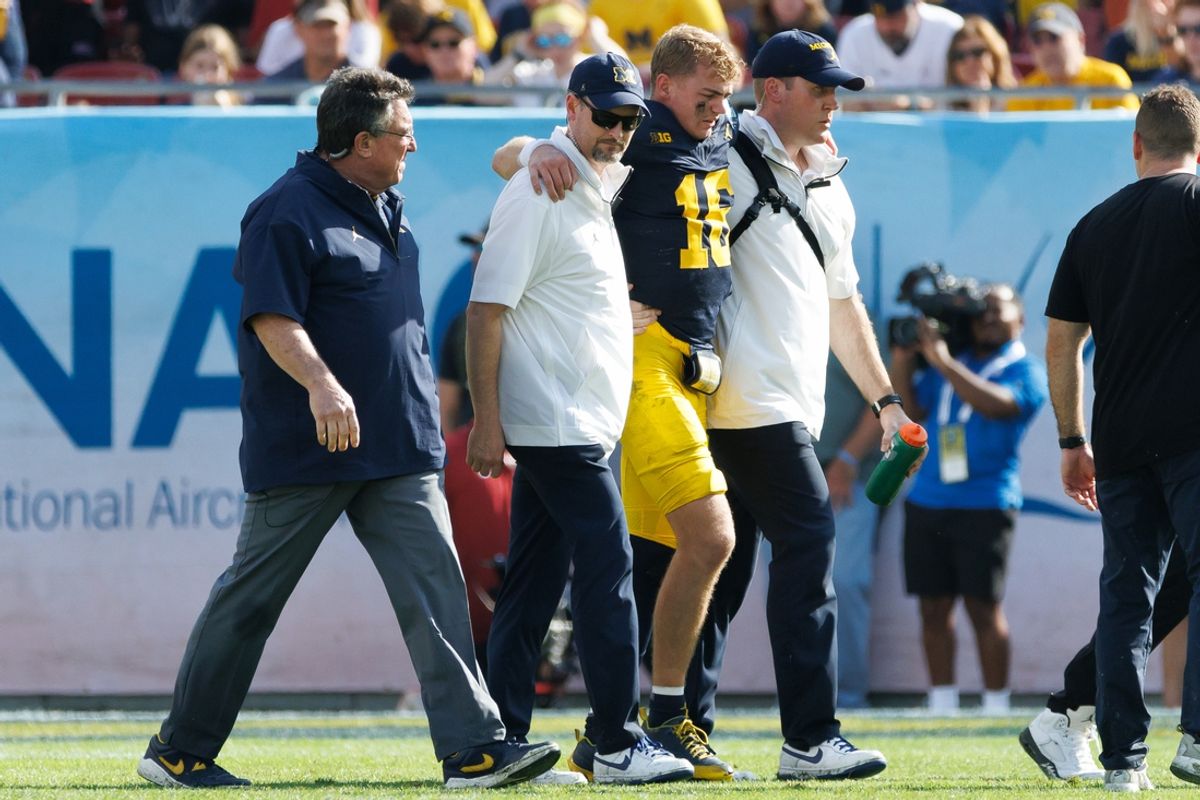 Dec 31, 2024; Tampa, FL, USA; Michigan Wolverines quarterback Davis Warren (16) is helped off the field after an injury against the Alabama Crimson Tide during the second half at Raymond James Stadium. Mandatory Credit: Matt Pendleton-Imagn Images