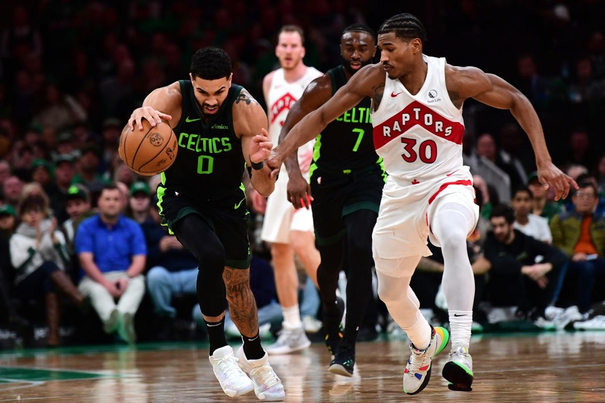 Dec 31, 2024; Boston, Massachusetts, USA;  Boston Celtics forward Jayson Tatum (0) controls the ball while Toronto Raptors guard Ochai Agbaji (30) defends during the first half at TD Garden. Mandatory Credit: Bob DeChiara-Imagn Images