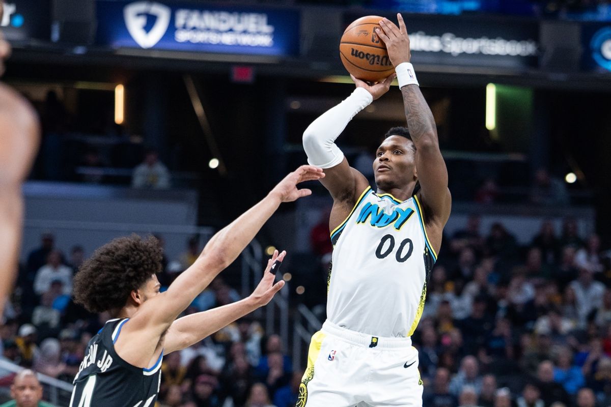Dec 31, 2024; Indianapolis, Indiana, USA; Indiana Pacers guard Bennedict Mathurin (00) shoots the ball while Milwaukee Bucks guard Andre Jackson Jr. (44) defends in the first half at Gainbridge Fieldhouse. Mandatory Credit: Trevor Ruszkowski-Imagn Images