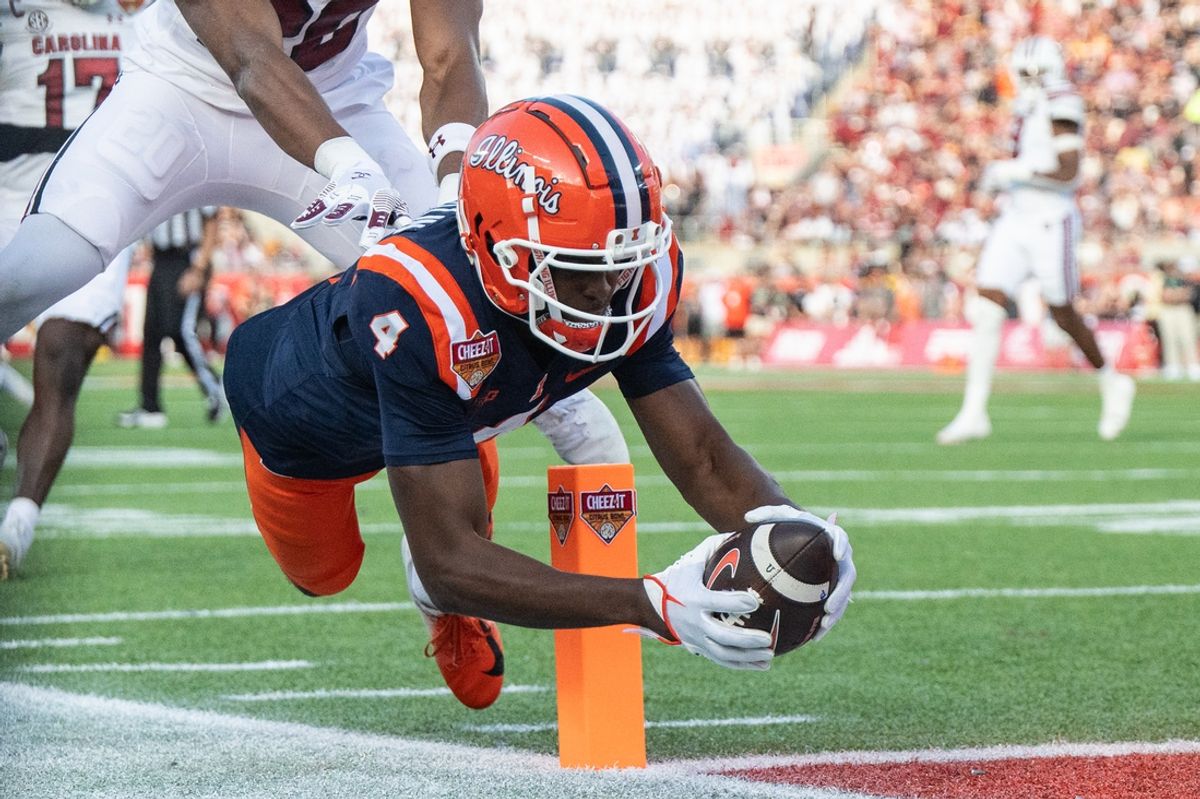 Dec 31, 2024; Orlando, FL, USA; Illinois Fighting Illini wide receiver Zakhari Franklin (4) dives after the catch for the touchdown against the South Carolina Gamecocks in the first quarter at Camping World Stadium. Mandatory Credit: Jeremy Reper-Imagn Images