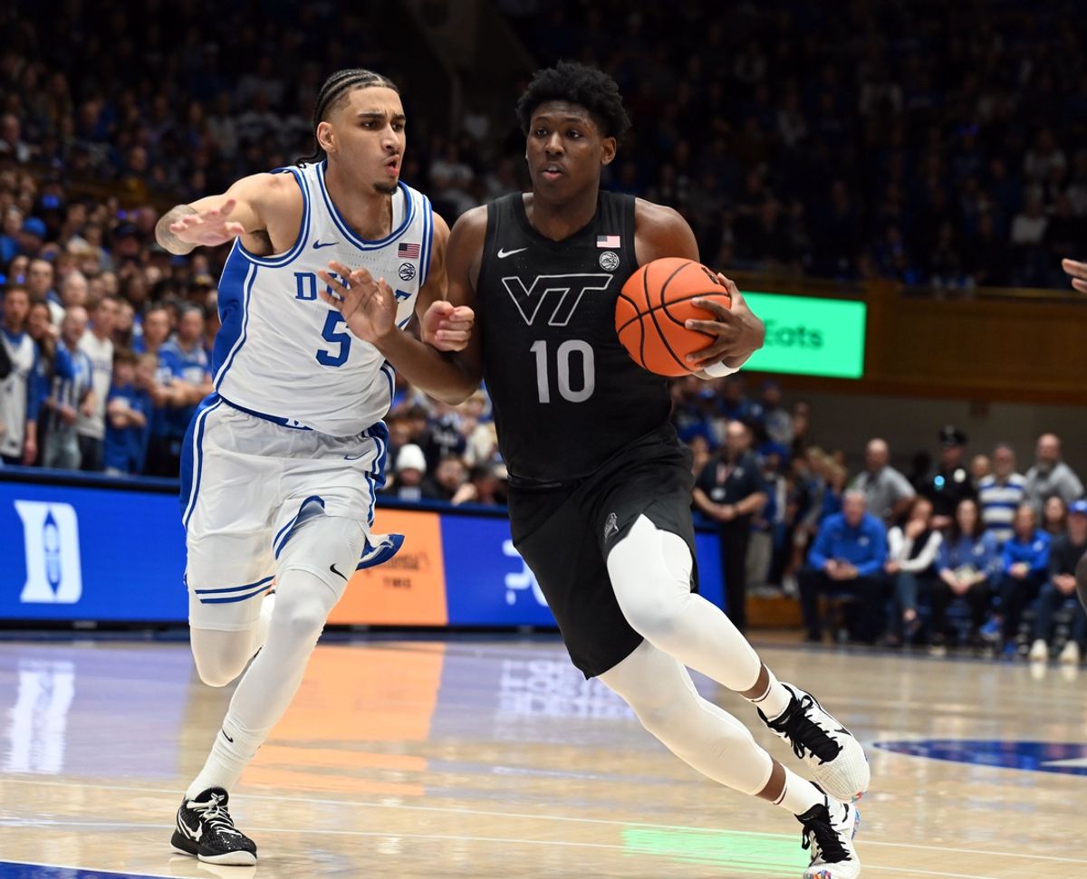 Dec 31, 2024; Durham, North Carolina, USA; Virginia Tech Hokies guard Tyler Johnson (10) drives to the basket as Duke Blue Devils guard Tyrese Proctor (5) defends during the first half at Cameron Indoor Stadium. Mandatory Credit: Rob Kinnan-Imagn Images