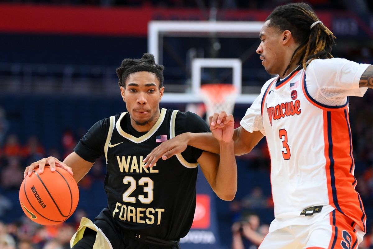 Dec 31, 2024; Syracuse, New York, USA; Wake Forest Demon Deacons guard Hunter Sallis (23) drives against Syracuse Orange guard Lucas Taylor (3) during the second half at the JMA Wireless Dome. Mandatory Credit: Rich Barnes-Imagn Images