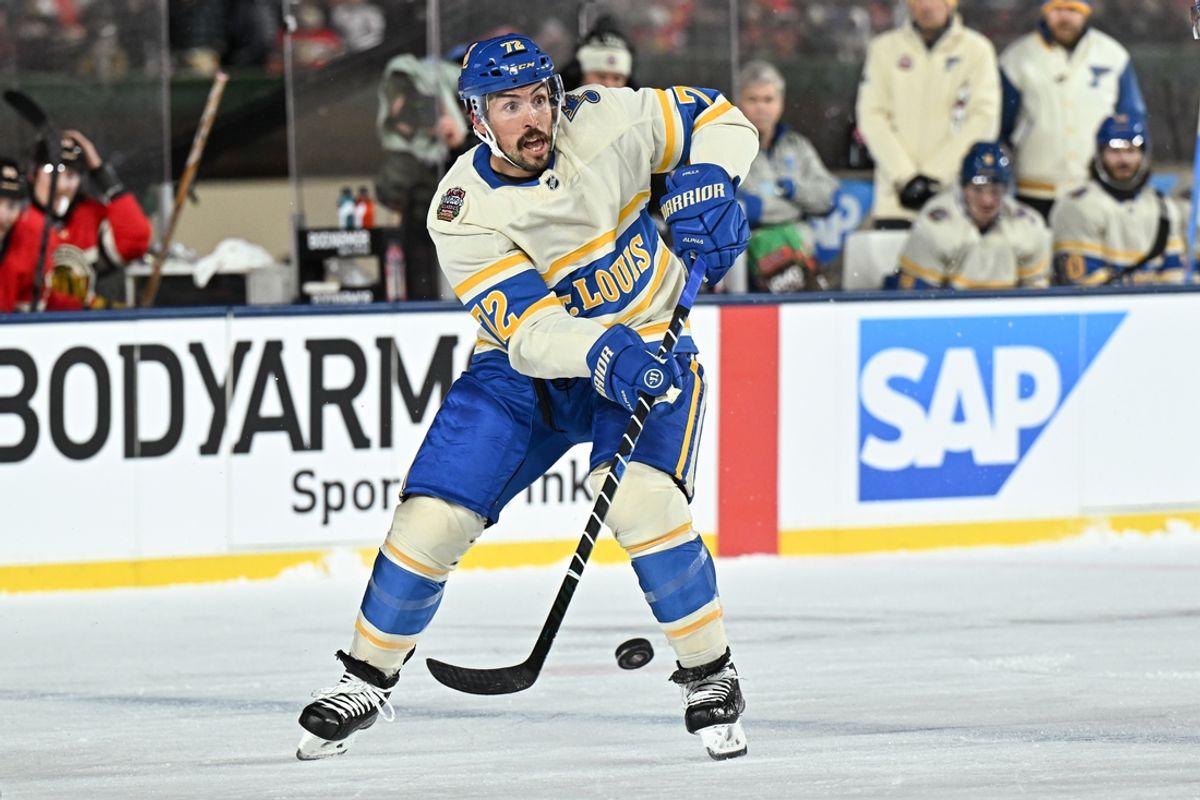 Dec 31, 2024; Chicago, Illinois, USA; St. Louis Blues defenseman Justin Faulk (72) passes the puck against the Chicago Blackhawks during the first period in the Winter Classic at Wrigley Field. Mandatory Credit: Daniel Bartel-Imagn Images