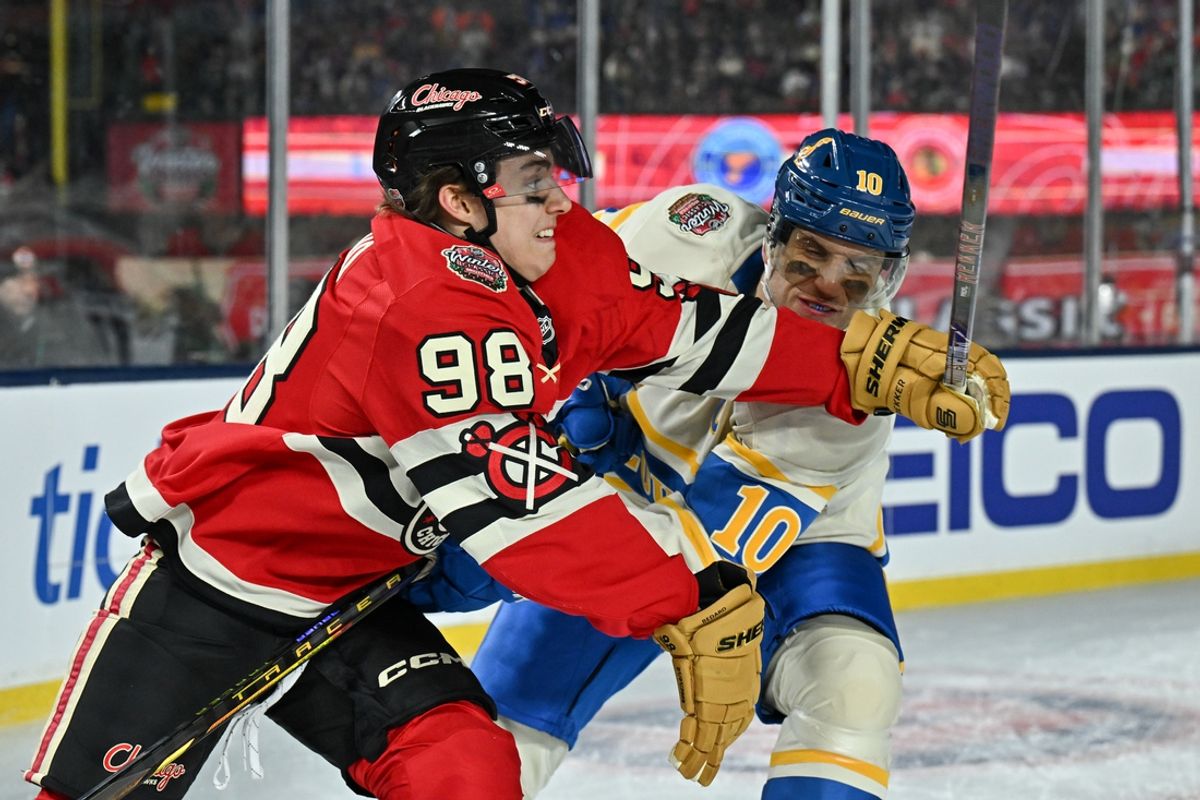 Dec 31, 2024; Chicago, Illinois, USA; Chicago Blackhawks center Connor Bedard (98) and St. Louis Blues center Brayden Schenn (10) skate after the puck during the second period in the Winter Classic at Wrigley Field. Mandatory Credit: Daniel Bartel-Imagn Images