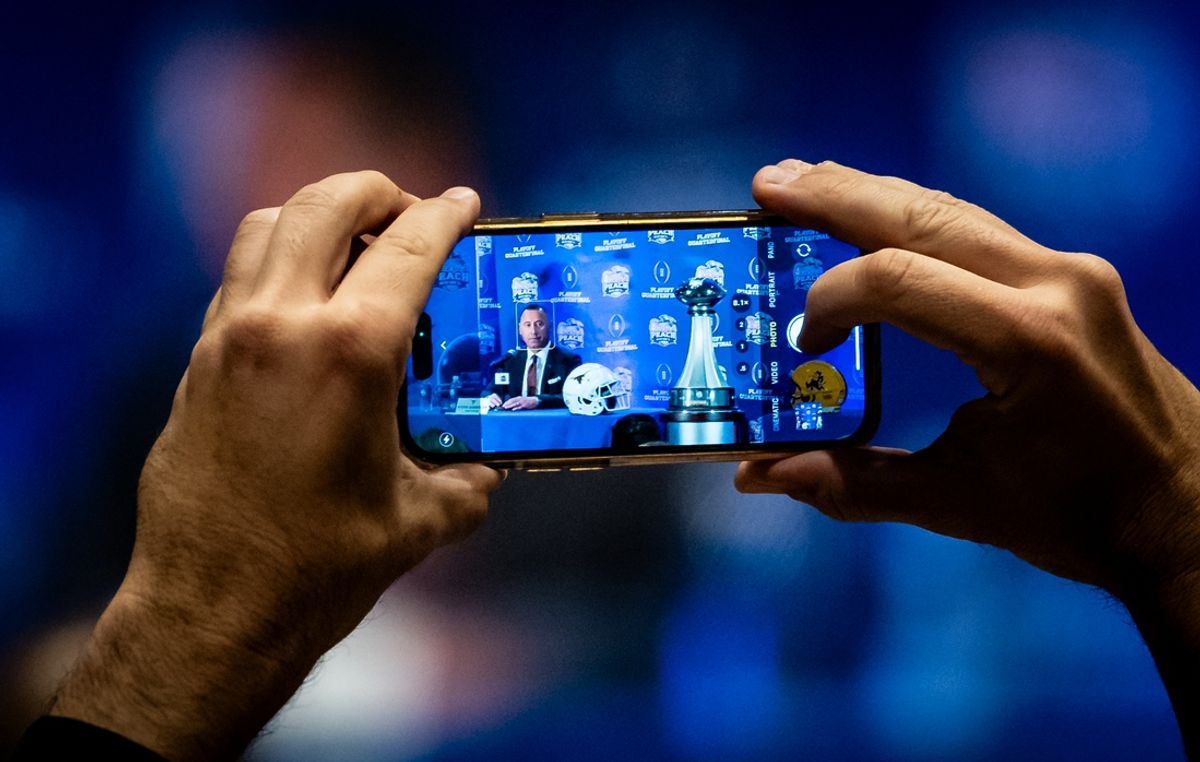 Dec 31, 2024; Atlanta, Georgia, USA; A media member takes a photo on a cellphone as Texas Longhorns head coach Steve Sarkisian speaks to the media at the Joint head coaches Press Conference at the Westin Peachtree Plaza in Atlanta, Georgia on Dec. 31, 2024, ahead of the Peach Bowl College Football Quarterfinal Game on New Years Day.  Mandatory Credit: Sara Diggins/USA TODAY Network via Imagn Images