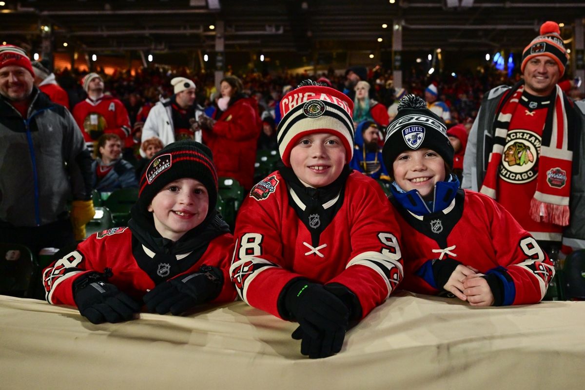 Dec 31, 2024; Chicago, Illinois, USA; Fans pose for photos during the second intermission in the Winter Classic between the Chicago Blackhawks and the St. Louis Blues at Wrigley Field. Mandatory Credit: Daniel Bartel-Imagn Images