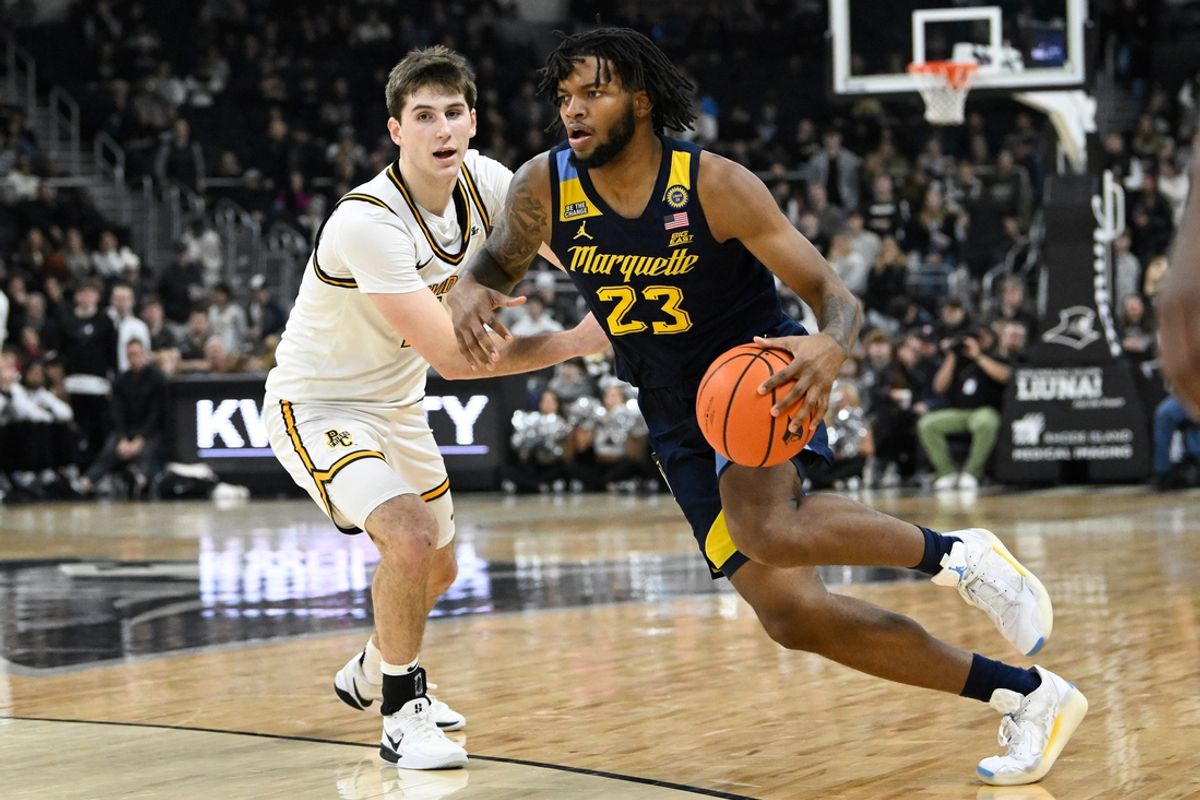 Dec 31, 2024; Providence, Rhode Island, USA; Marquette Golden Eagles forward David Joplin (23) drives to the basket against Providence Friars forward Ryan Mela (11) during the second half at Amica Mutual Pavilion. Mandatory Credit: Eric Canha-Imagn Images