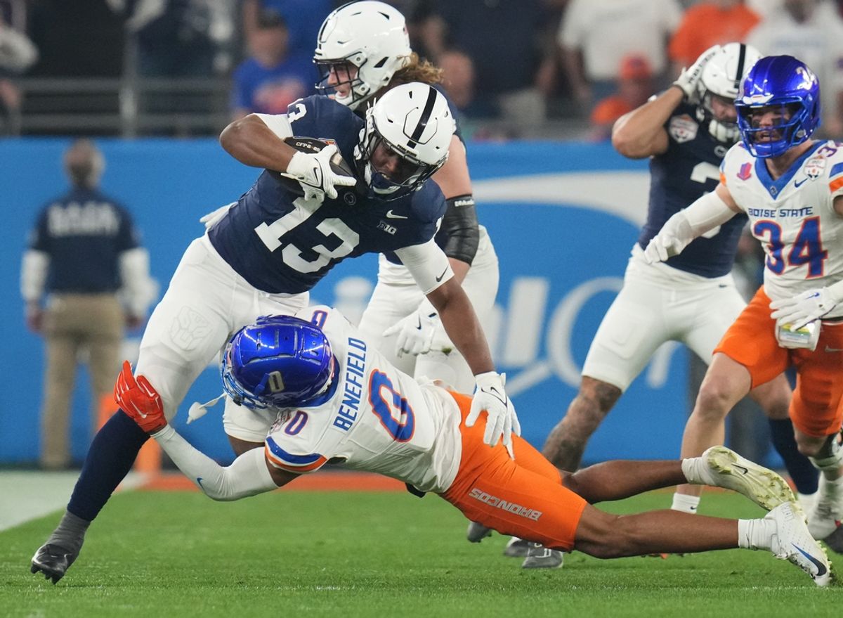 Penn State Nittany Lions running back Kaytron Allen (13) is tackled by Boise State Broncos safety Ty Benefield (0) during their Vrbo Fiesta Bowl matchup at State Farm Stadium in Glendale on Dec. 31, 2024.