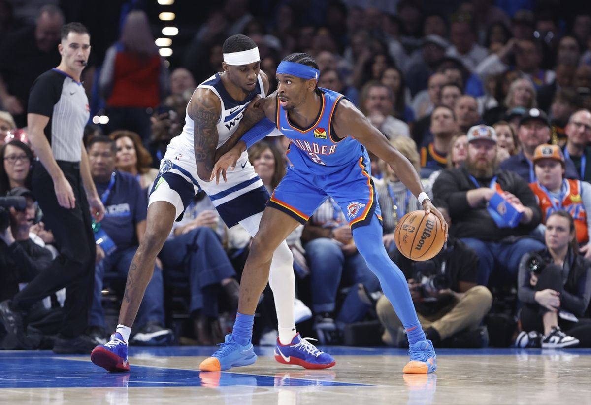 Dec 31, 2024; Oklahoma City, Oklahoma, USA; Minnesota Timberwolves forward Jaden McDaniels (3) defends a drive by Oklahoma City Thunder guard Shai Gilgeous-Alexander (2) during the second quarter at Paycom Center. Mandatory Credit: Alonzo Adams-Imagn Images