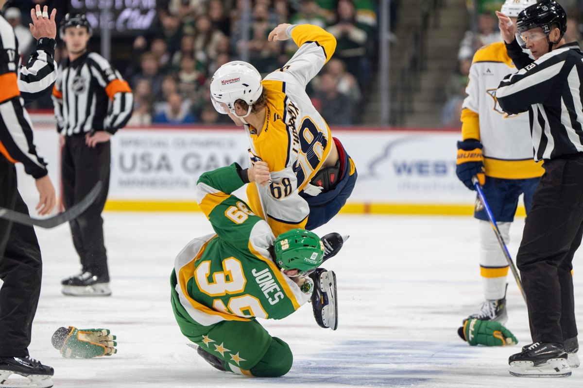 Dec 31, 2024; Saint Paul, Minnesota, USA; Minnesota Wild center Ben Jones (39) throws Nashville Predators left wing Zachary L'Heureux (68) during a fight in the first period at Xcel Energy Center. Mandatory Credit: Matt Blewett-Imagn Images