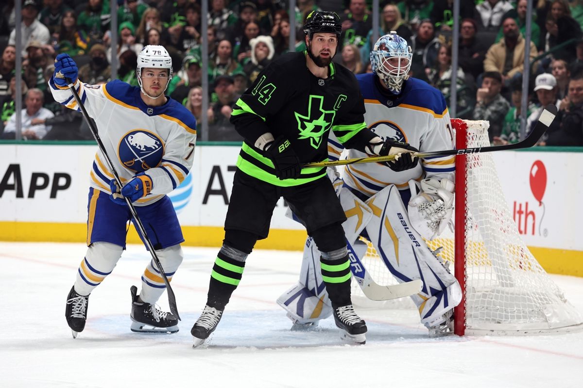 Dec 31, 2024; Dallas, Texas, USA; Dallas Stars left wing Jamie Benn (14) stands in the crease against Buffalo Sabres defenseman Jacob Bryson (78) and goaltender Ukko-Pekka Luukkonen (1) during the second period at American Airlines Center. Mandatory Credit: Tim Heitman-Imagn Images