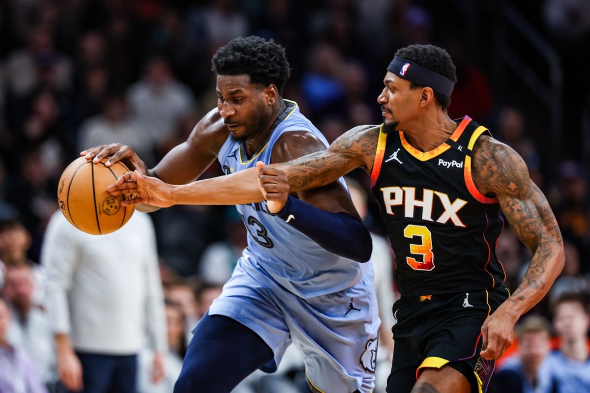 Dec 31, 2024; Phoenix, Arizona, USA; Memphis Grizzlies forward-center Jaren Jackson Jr. (13) runs with the ball while Phoenix Suns guard Bradley Beal (3) attempts to hit the ball out of his hand during the first quarter of the game at Footprint Center. Mandatory Credit: Aryanna Frank-Imagn Images