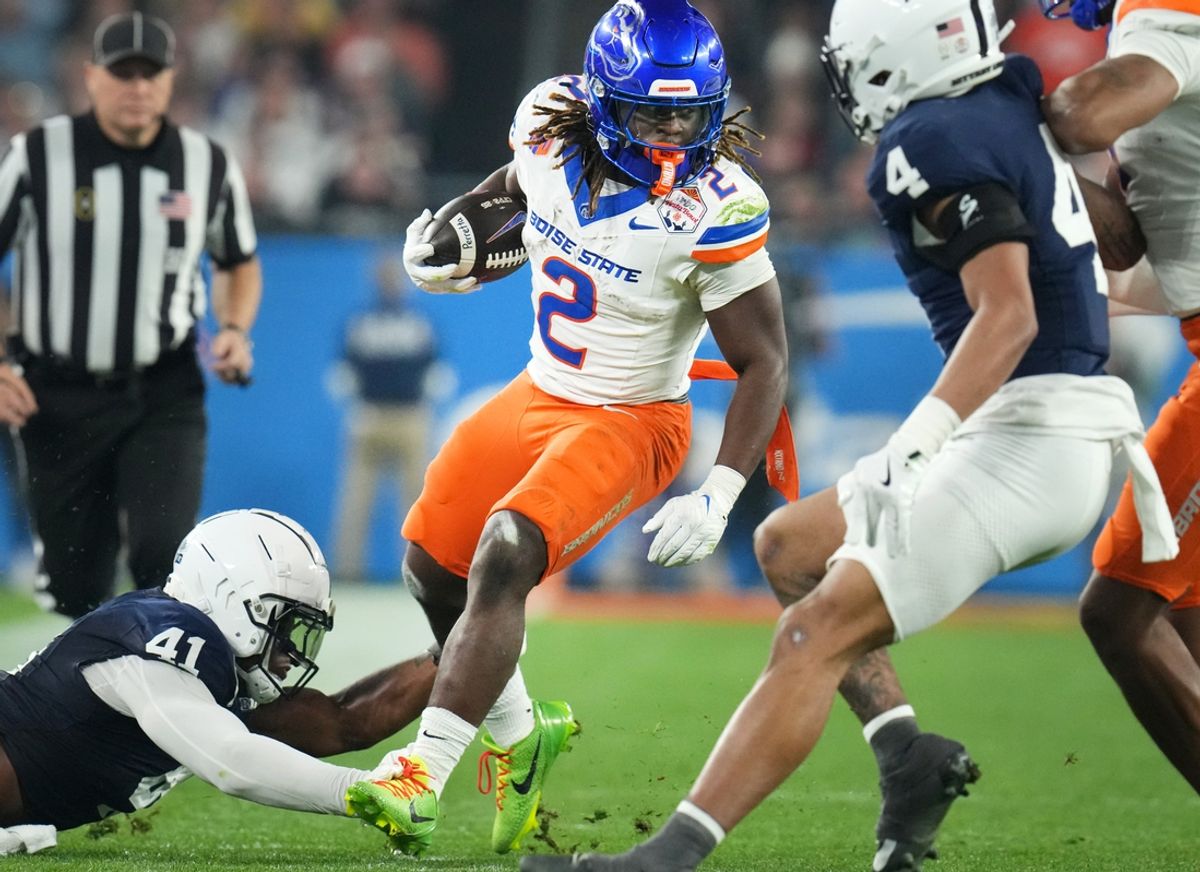 Boise State Broncos running back Ashton Jeanty (2) runs past Penn State Nittany Lions linebacker Kobe King (41) during their Vrbo Fiesta Bowl matchup at State Farm Stadium on Dec. 31, 2024.
