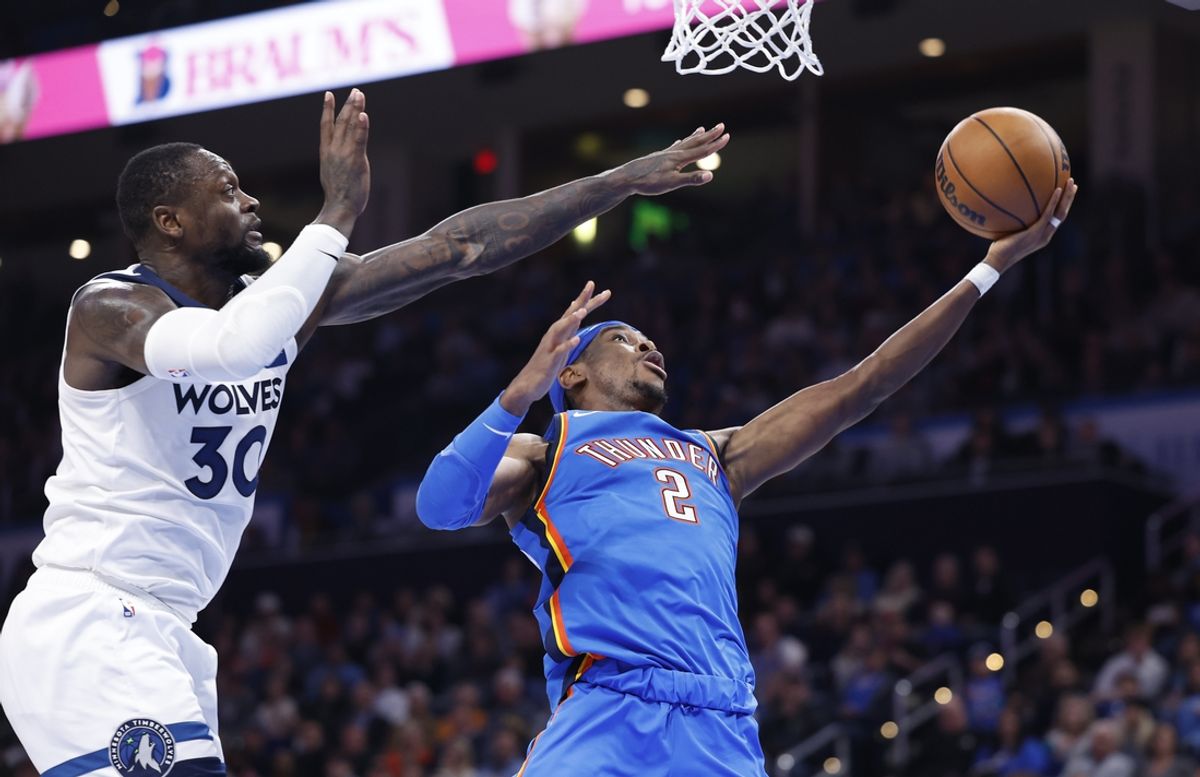 Dec 31, 2024; Oklahoma City, Oklahoma, USA; Oklahoma City Thunder guard Shai Gilgeous-Alexander (2) goes to the basket beside Minnesota Timberwolves forward Julius Randle (30) during the second half at Paycom Center. Mandatory Credit: Alonzo Adams-Imagn Images