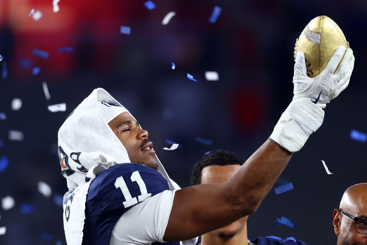 Dec 31, 2024; Glendale, AZ, USA; Penn State Nittany Lions defensive end Abdul Carter (11) reacts with the trophy after the game against the Boise State Broncos in the Fiesta Bowl at State Farm Stadium. Mandatory Credit: Mark J. Rebilas-Imagn Images