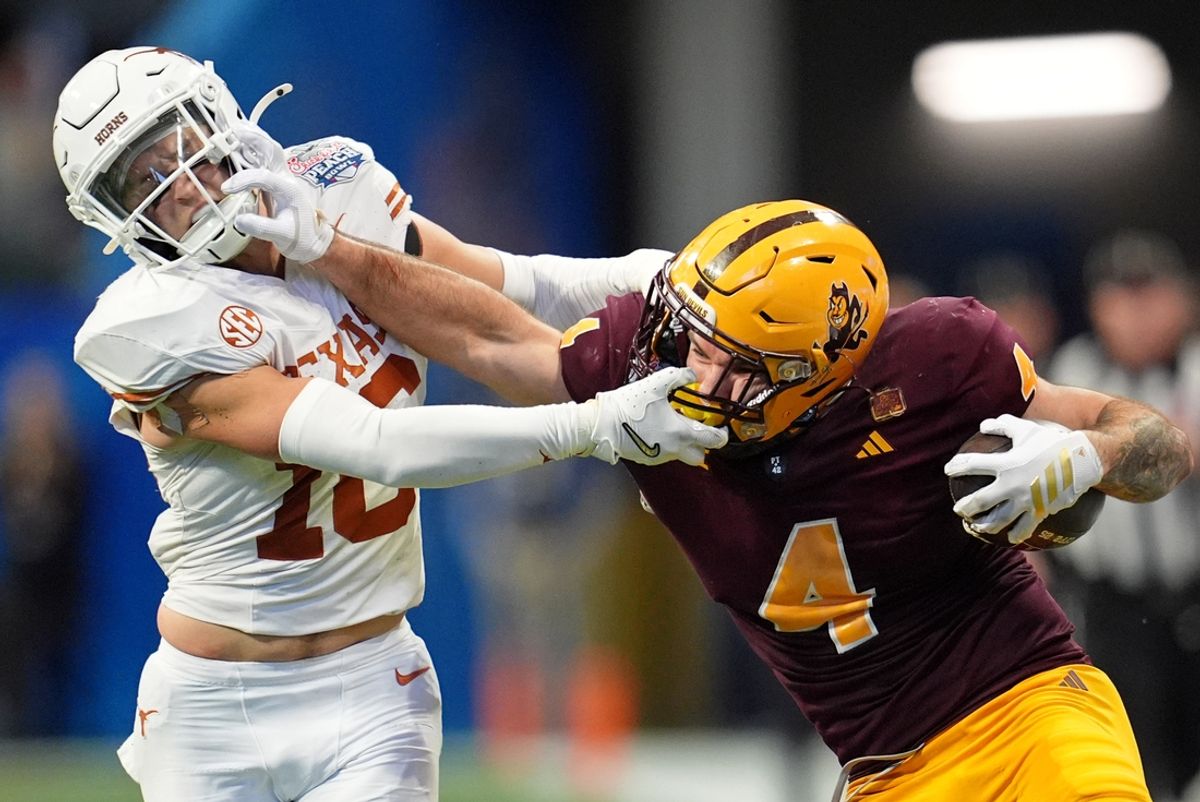 Jan 1, 2025; Atlanta, GA, USA; Arizona State Sun Devils running back Cam Skattebo (4) and Texas Longhorns defensive back Michael Taaffe (16) push each other during the second half of the Peach Bowl at Mercedes-Benz Stadium. Mandatory Credit: Dale Zanine-Imagn Images