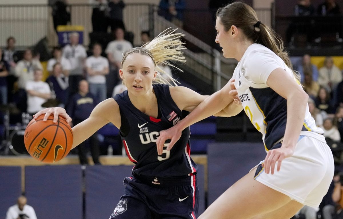 UConn guard Paige Bueckers (5) makes a move on Marquette guard Halle Vice (22) during the first half of their game Wednesday, January 1, 2025 at the Al McGuire Center in Milwaukee, Wisconsin.