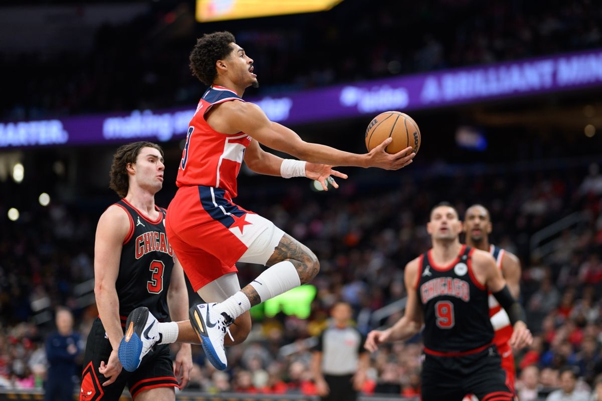 Jan 1, 2025; Washington, District of Columbia, USA; Washington Wizards guard Jordan Poole (13) shoots a lay up as Chicago Bulls guard Josh Giddey (3) defends during the first quarter at Capital One Arena. Mandatory Credit: Reggie Hildred-Imagn Images